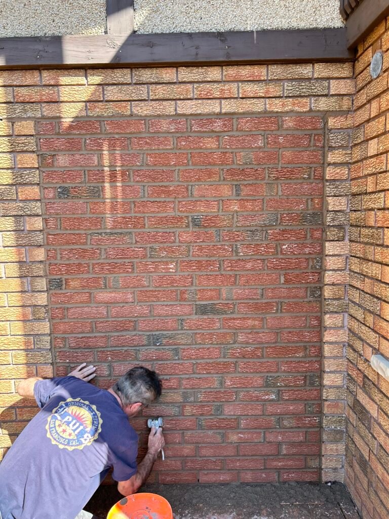 Closing an opening with bricks.